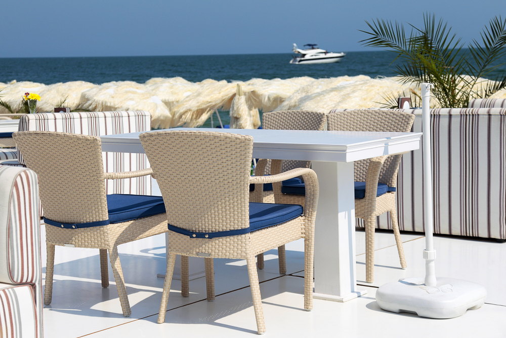 Dining,Table,And,Chairs,On,The,Beach,On,A,Summer