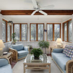 Sunroom,With,Wood,Ceiling,Beam,And,Wicker,Furniture